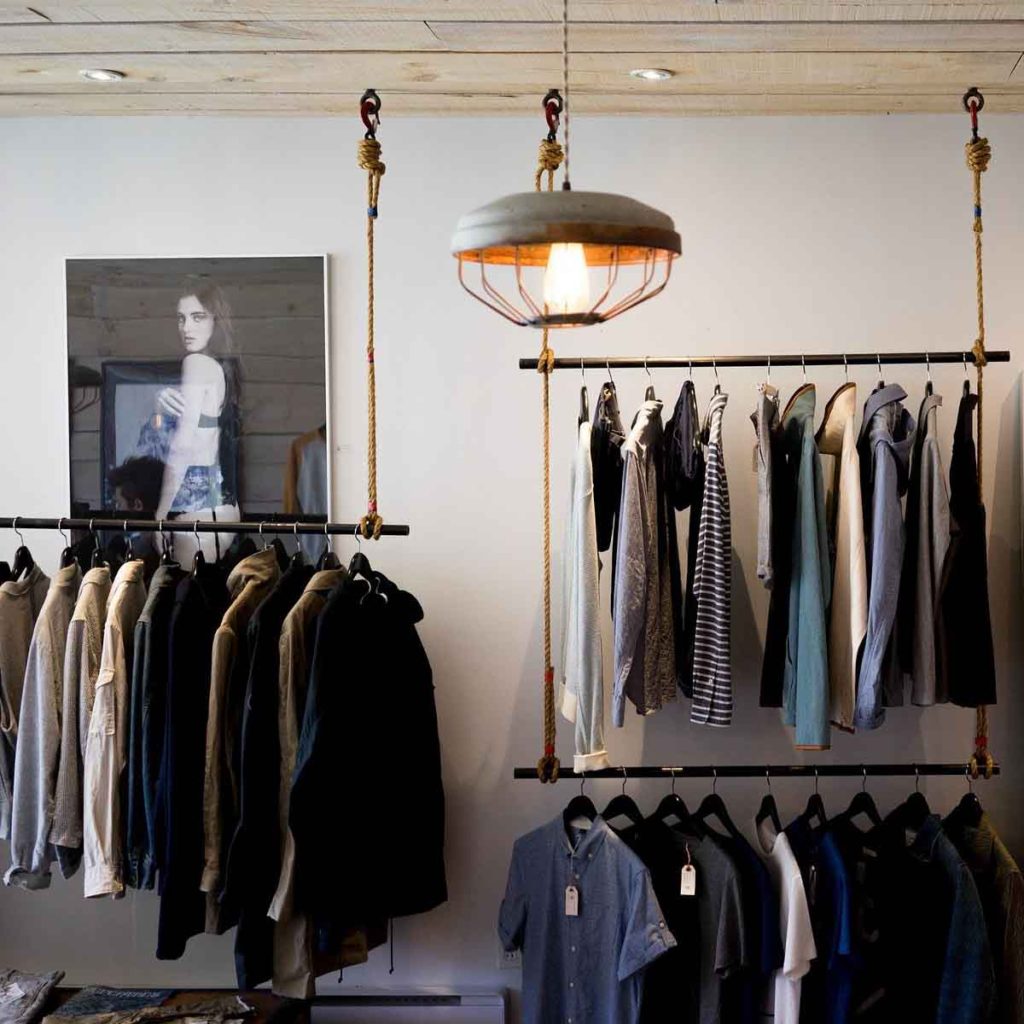 Small boutique clothing store with casual clothes on hangers