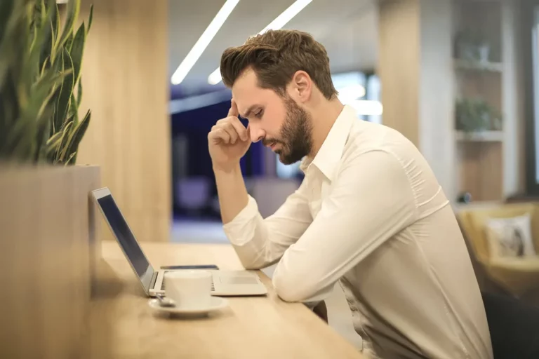 Man sitting at desk working on laptop