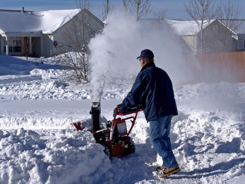Man plowing driveway with snowblower